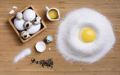 Mixing egg and flour for dough, ingredients for baking.