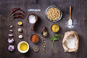 Raw cooking ingredients flat lay on wooden table.