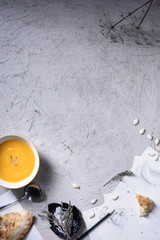 Roasted kabocha squash soup served with herbs,  sour cream.