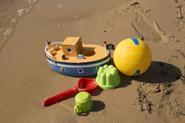 Toys on the sandy beach near the water