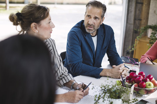 High angle view of businessman discussing with colleagues in portable office truck