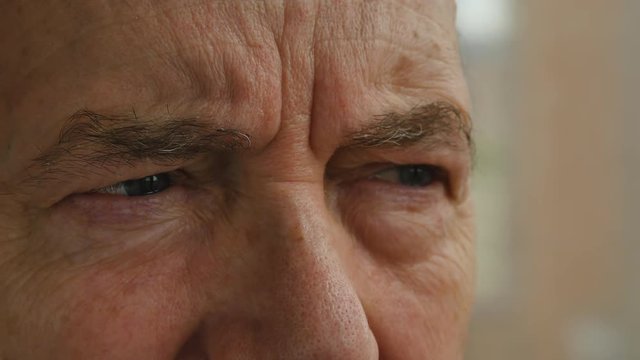 Eyes Of An Elderly Man Close Up Urban Buildings In The Background