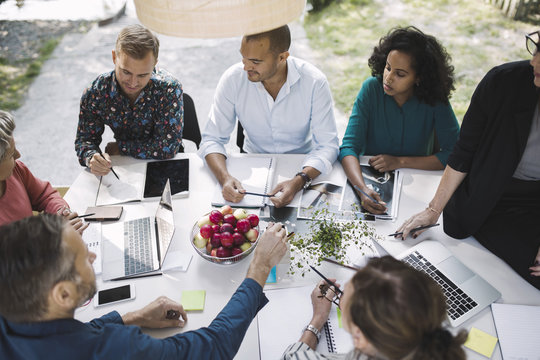 High angle view of business people planning strategy at desk in portable office truck