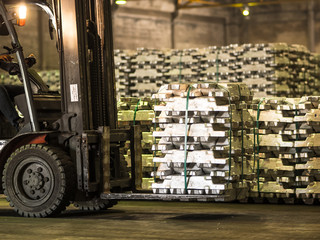 Aluminium ingots handling by forklift in warehouse