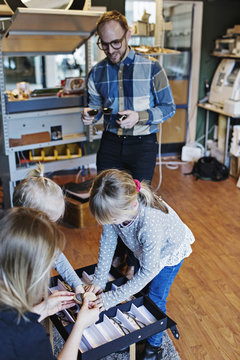 Owners with children at eyeglasses workshop