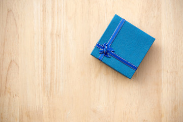 blue gift box on wooden background. vintage tone