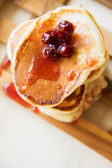 Blueberry pancakes on a contrasting black background. Close up