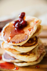 Blueberry pancakes on a contrasting black background. Close up