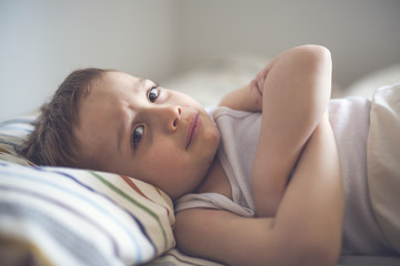 Obraz premium Young Boy on bed