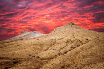 Fototapeta na wymiar Sunset over muddy volcanoes, Buzau county, Romania. Active mud volcanoes landscape in Europe.
