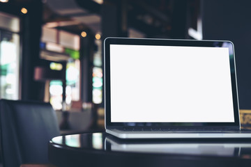 Mockup image of laptop with blank white screen on wooden table in coffee shop