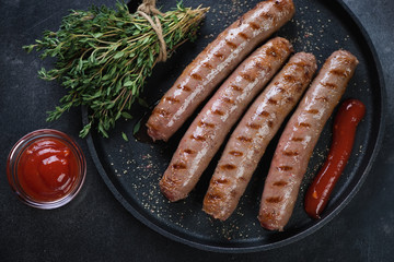 Above view of grilled marbled beef sausages in a frying pan, horizontal shot