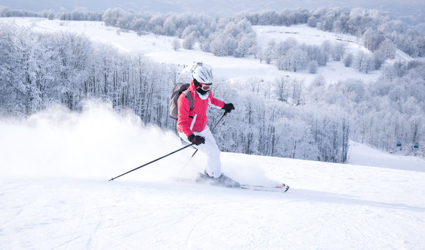 Woman skier skiing on mountain slope 