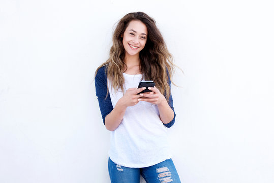 Cool Young Woman Smiling With Mobil Phone Against White Background