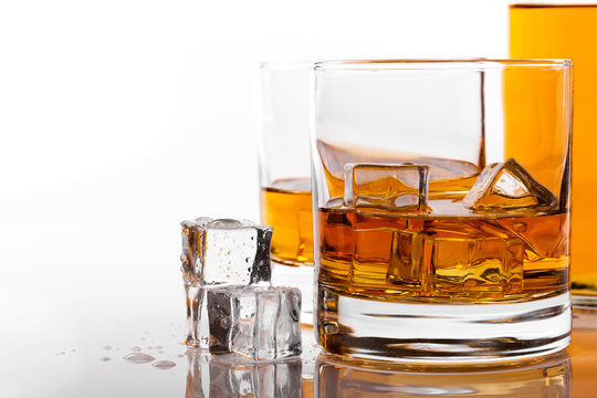whiskey glass with ice on white background