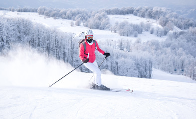 Woman skier in mountain ski resort