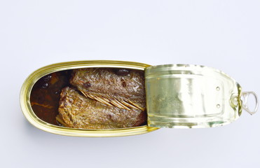 salty fried fish in tin canned opened on white background