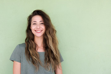 smiling young woman against green background
