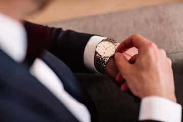 watch with white dial on the hand of a man in a white shirt © boykovi1991
