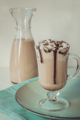 Hot coffee latte with thick foam and grated chocolate. Vintage toned.