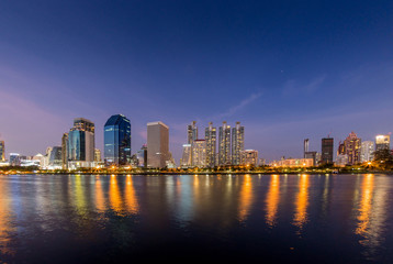 Scenic view of Public park (Benjakitti park) in downtown Bangkok with buildings background in evening time.