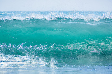 Fototapeta na wymiar Blue barrel wave in tropical ocean. Wave crashing and sun light