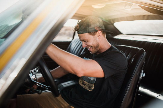 Smiling man driving car