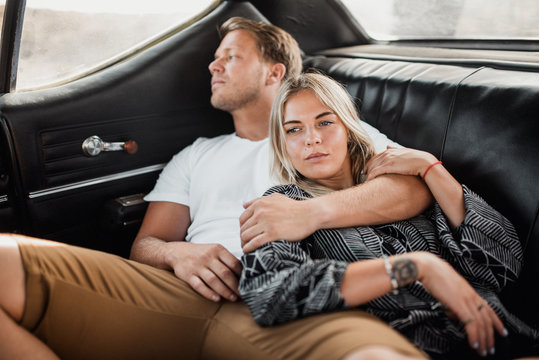 Couple embracing while relaxing in the car