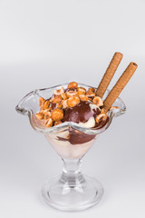 Ice cream with hazelnuts and chocolate on isolated white background