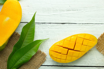 mango on a white wood background. tinting. selective focus on the mangos slices