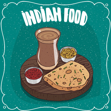 Traditional food, dish of Indian cuisine, round flatbread like Roti, Naan, Chapati, Papadum or Paratha, on wooden plate with sauces like chutney and masala chai tea