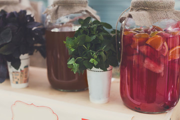 Closeup of lemonades in glass jars at restaurant background