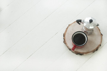 White wooden background with cup of coffee and kattle on wooden eco tray