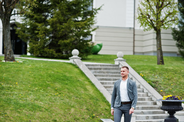 Fashionable man at grey suit on ceremony wedding anniversary.