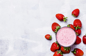 Strawberry milkshake with berries, food background, top view