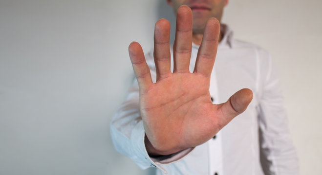 Man doing stop gesture with the right hand.