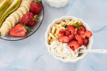 Fresh cottage cheese, sour cream, strawberry, banan and pear afor healthy eating