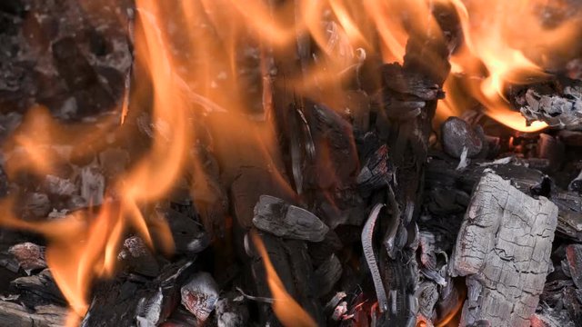 Burning wood in a furnace or fireplace. Clip footage 4K, UHD, Ultra HD