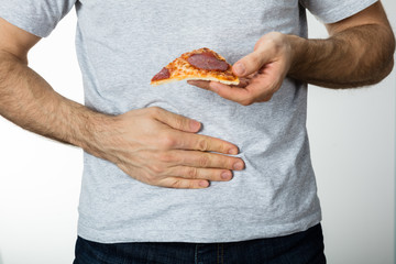 Man With Hand On Stomach Holding Pizza Slice