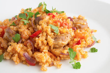 wheat pelaf with meat, tomato, onion, and pepper