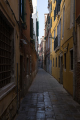 Fototapeta na wymiar A narrow venetian alley in Venice, Italy