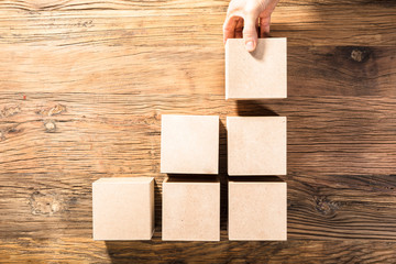 Person's Hand Arranging Wooden Block