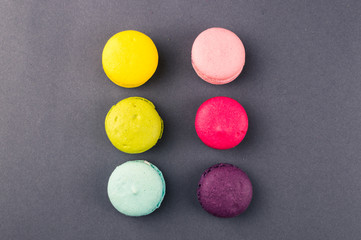 Colourful french macaroons on the grey background, Top view
