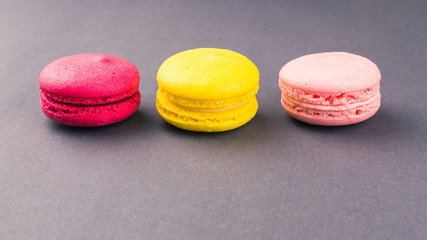 Colourful french macaroons on the grey background