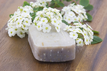 bar of natural soap and white flowers