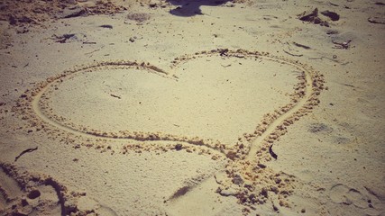 Sign of love written in sand