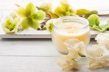 green flowers and lit candle