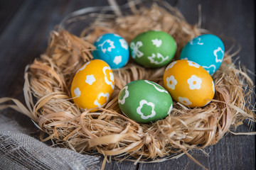 colorful eggs in a wicker nest
