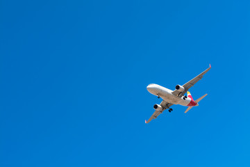 Low Angle View of Airplane Against Blue Sky