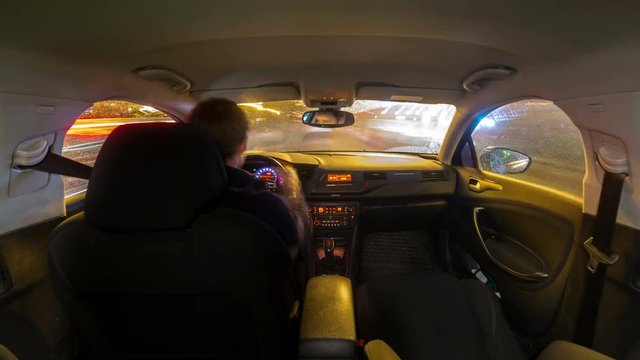 Rainy City road view from inside car natural light street and other cars is motion blurred Timelapse video 